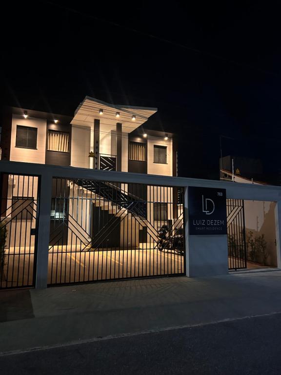 a house with a gate in front of it at night at LD Smart Residence in Castanhal