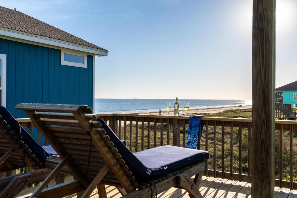 a deck with two chairs and a view of the beach at Ocean View l Pet Friendly in Gilchrist