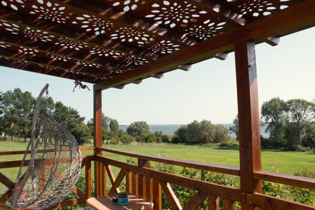 a porch with a view of a field at z widokiem na zalew in Sułomino