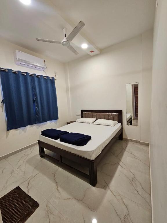 a bedroom with a bed and a blue curtain at Zen Villa in Murūd