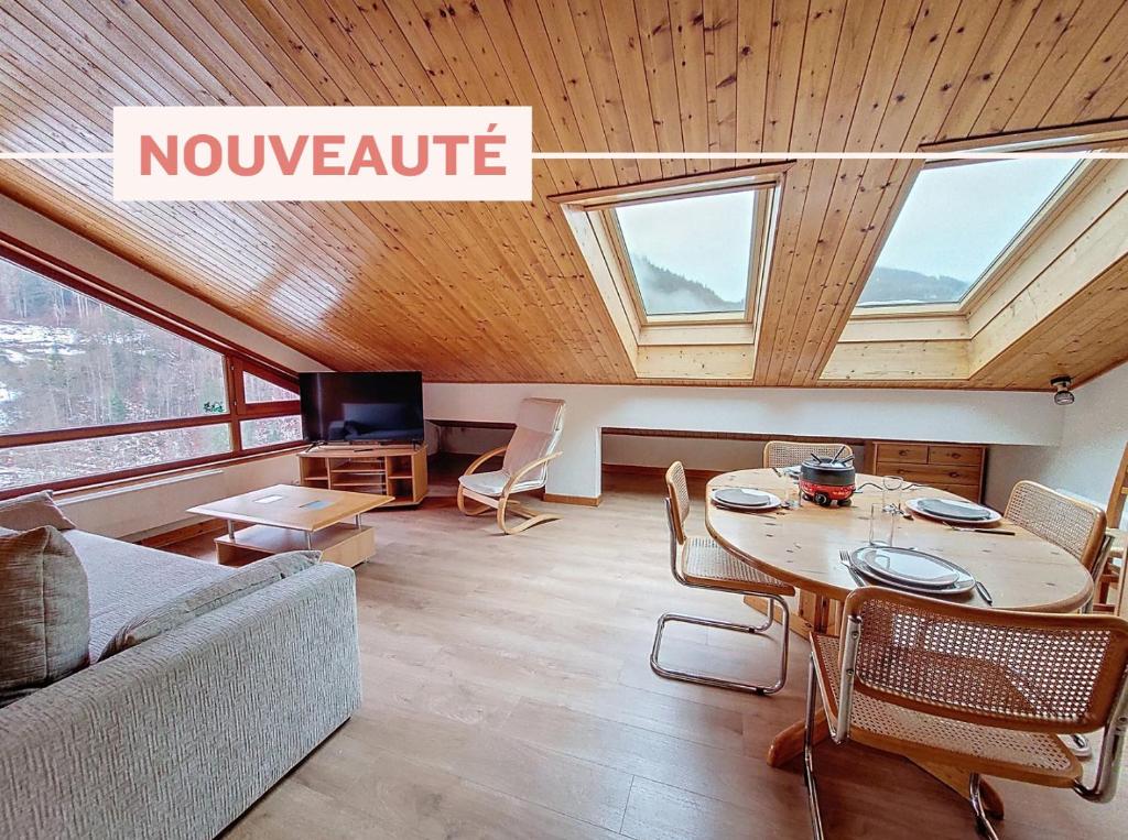a living room with a couch and a table at Enchaple A5 in Saint-Jean-d'Aulps