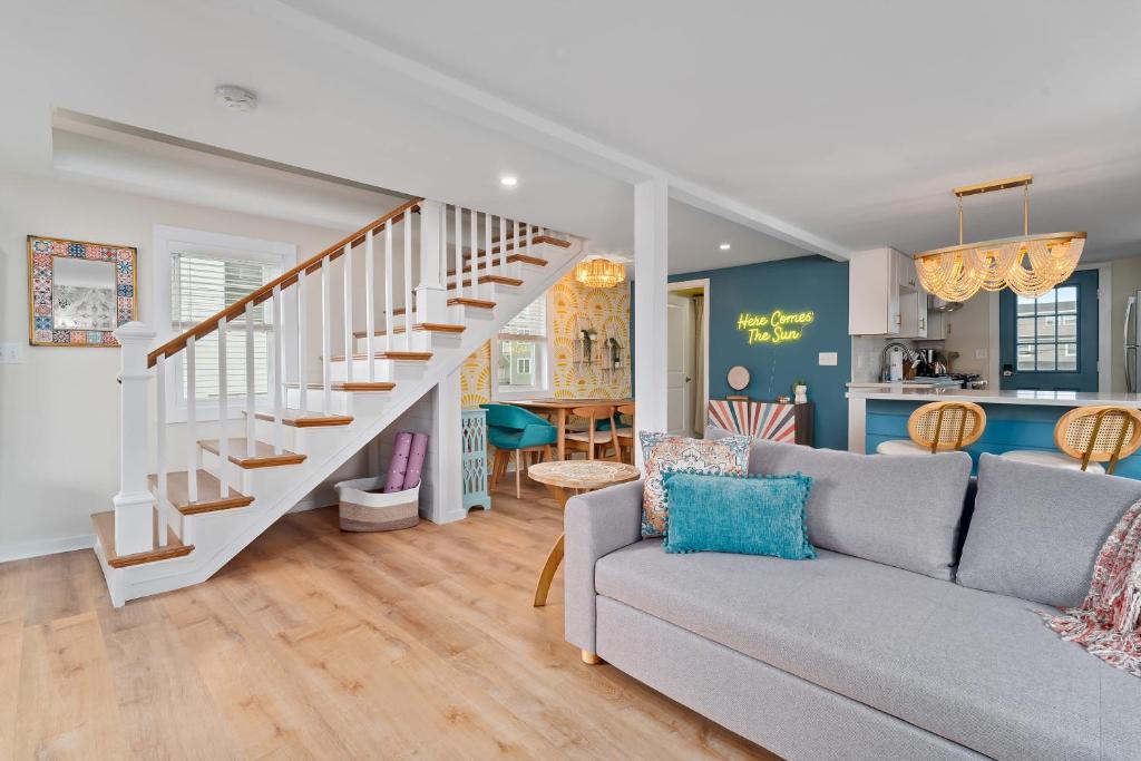 a living room with a couch and a staircase at Salisbury Sol Pet Friendly Private Balconies in Salisbury
