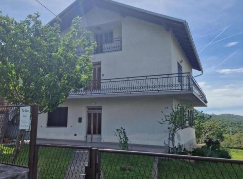a white house with a fence in front of it at Apartment Sea View in Karlobag