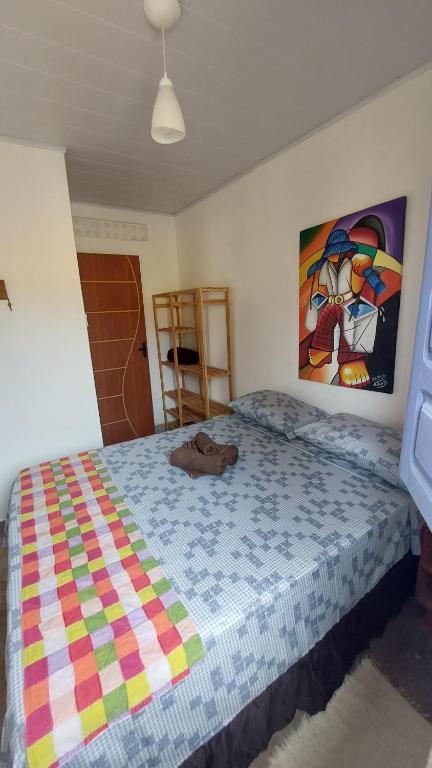 a bedroom with a bed with a stuffed animal on it at Casa da Piscina in Maceió