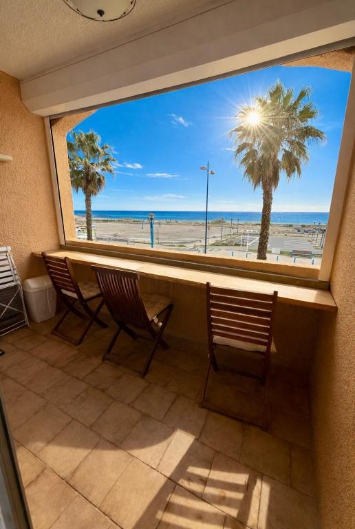 a view of the beach from a room with a window at Studio cabine première ligne in Fleury