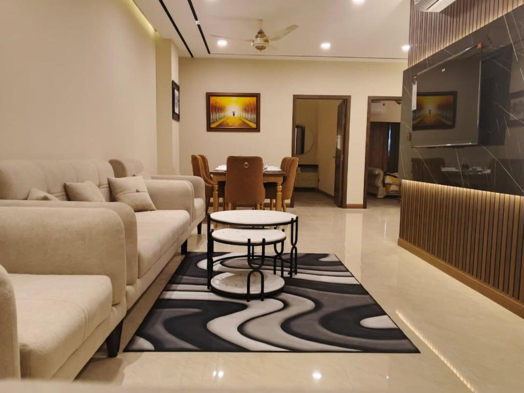a living room with a couch and a table at Premium 3BHK with UPS, across Giga Mall, Pool Included in Islamabad