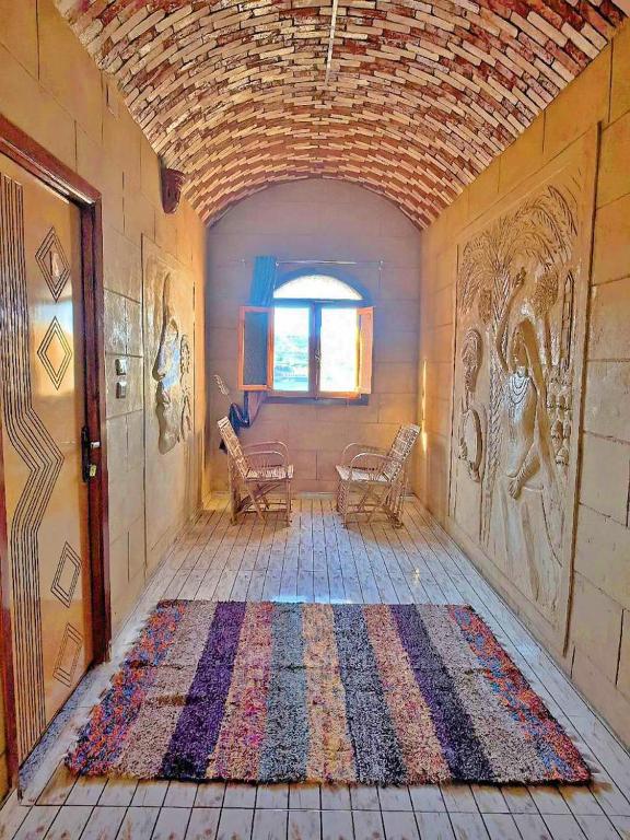 a hallway with a rug on the floor in a house at Labib Guest house in Aswan