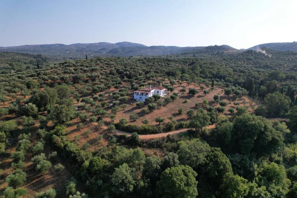 an aerial view of a house on a hill at Lióspito & Kochýli Constellation in Néa Koróni