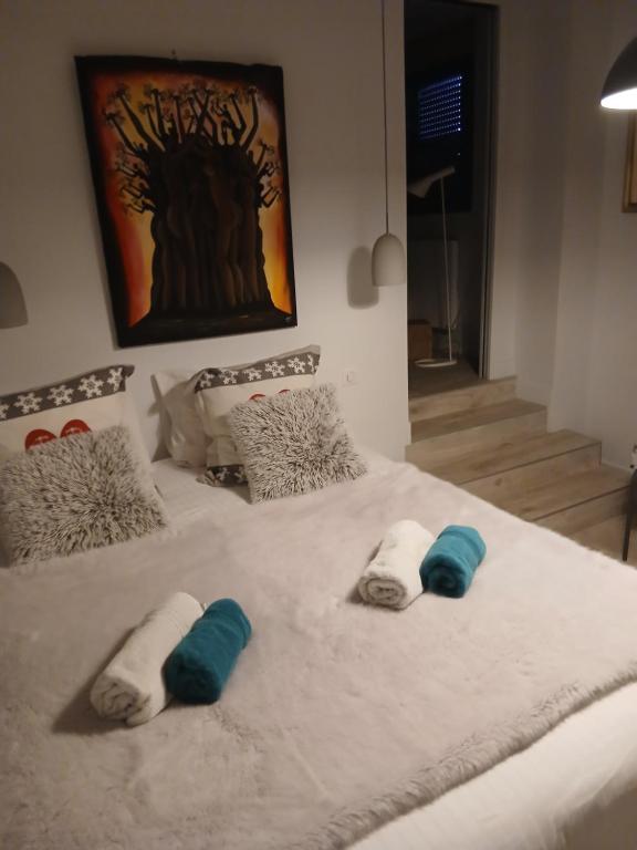a bed with three pillows on top of it at Chezgege in Valloire