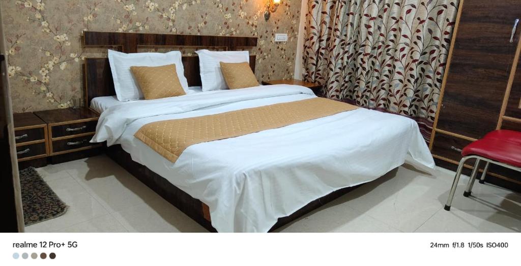 a bedroom with a large bed and a red chair at Dal frozen in Srinagar