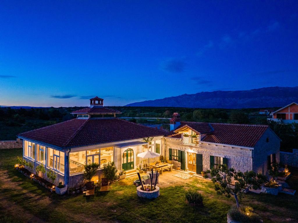 an aerial view of a house with lights on at Family holiday home Villa Vidonjica in Novalja