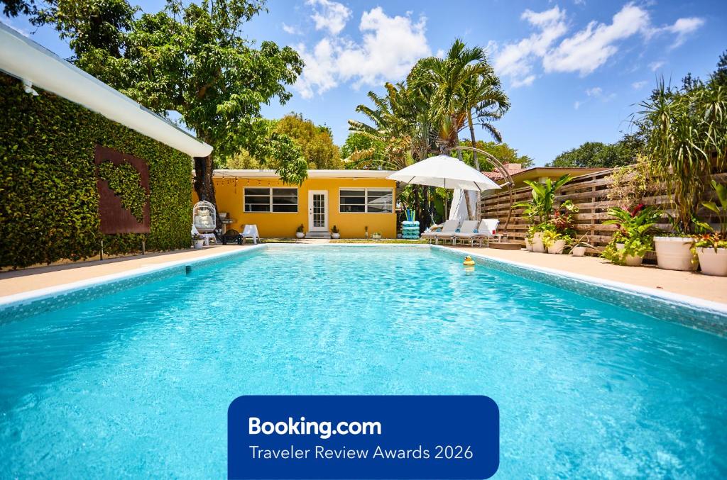 a swimming pool in front of a house at Resort-Style Home with Pool House in Miami