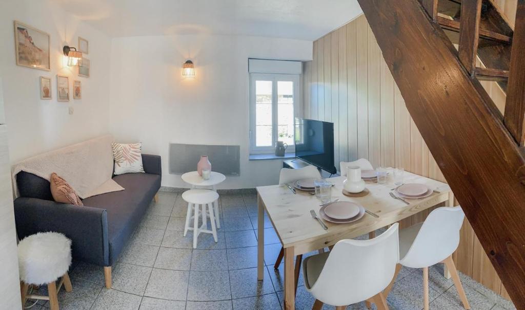 a living room with a couch and a table at Escapade Pirouaise - la Salicorne in Pirou