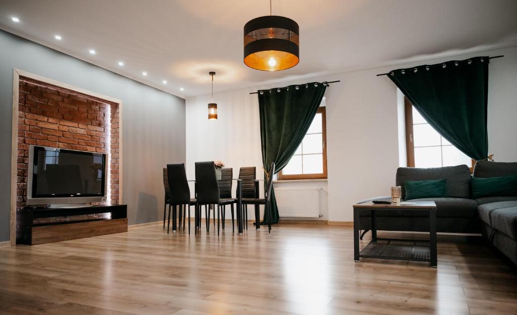 a living room with a couch and a table at Apartament Damian in Kamienna Góra
