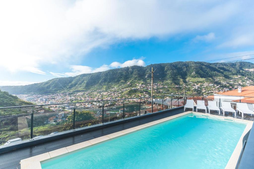 a swimming pool with a view of a mountain at Villa Sofia by Atlantic Holiday in Machico