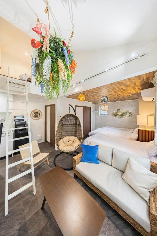 a bedroom with a king bed and a couch at suite Funabashi LAGOON2 #201 in Funabashi