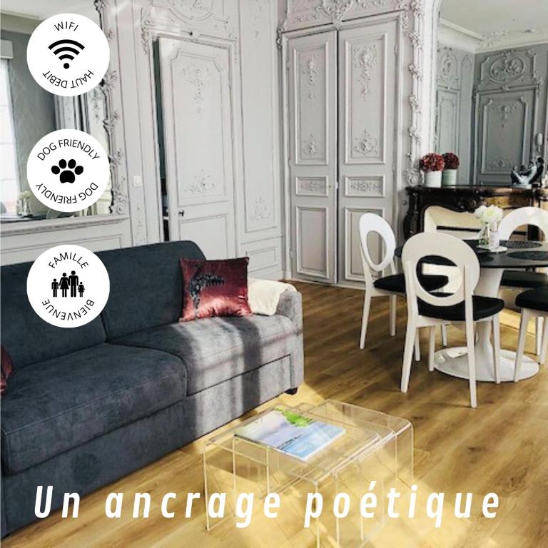 a living room with a couch and a table at Maison Gabriel Appartement PLUME in Abbeville