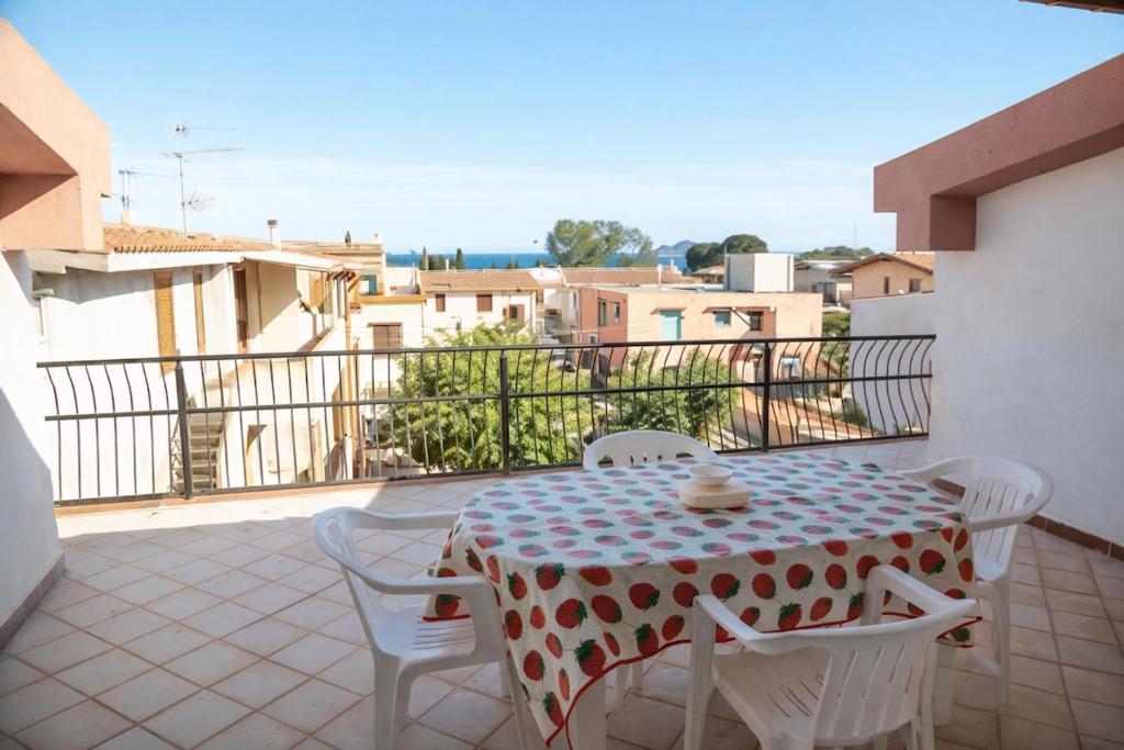 a table and chairs sitting on a balcony at La Mansarda Navarrese in Santa Maria Navarrese