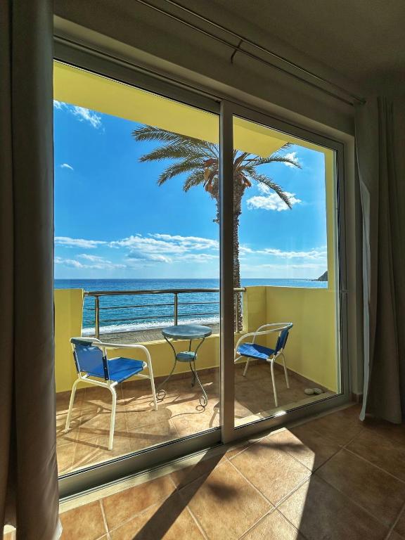 a view of the ocean from the balcony of a condo at Pelagos Apartments in Myrtos