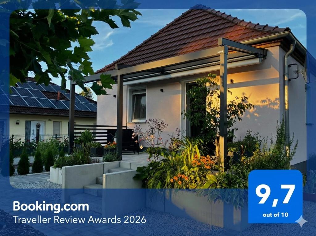 a house with a sign that reads booking a traveller review awards at Ferienhaus Albertus in Cottbus