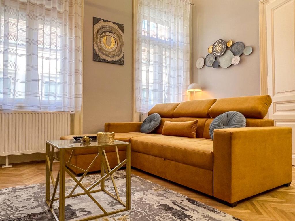 a living room with a couch and a table at Frida Loft in Pécs