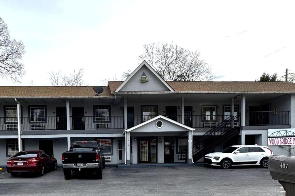 a building with cars parked in a parking lot at Woodbridge Inn By OYO Rome in Rome