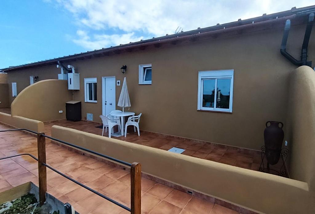 a balcony of a house with a table and chairs at Casas Quemahierro in Icod de los Vinos