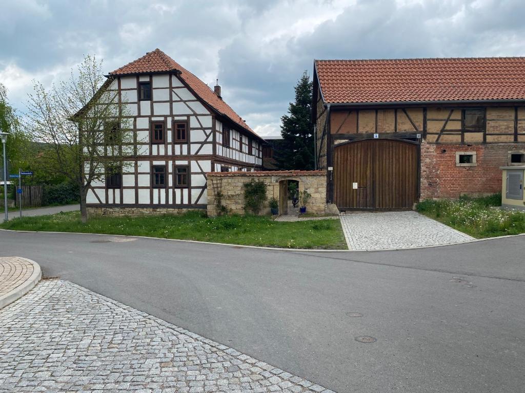 a house and a building with a garage and a street at Schöne Tage im Denkmal in Bittstädt
