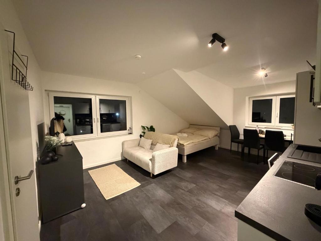 a living room with a bed and a couch and a table at Ferienwohnung Verissimo in Ittlingen