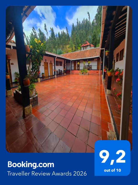 a courtyard of a house with a tiled sidewalk at Hotel MAXIRUMA - Villa TAMAUKA in Iza