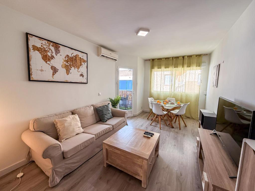 a living room with a couch and a table at Avenida Principal muy cerca de la playa - By Aloha Palma in Águilas