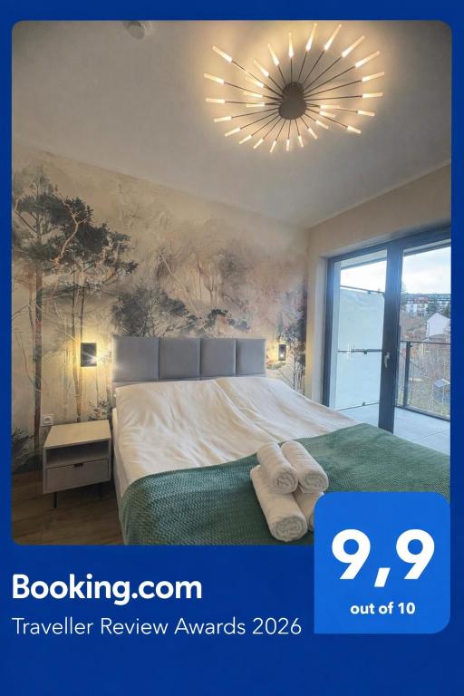 a bedroom with a large bed and a large chandelier at Belle View Strumyk 212 - Mountain View & SPA in Szklarska Poręba
