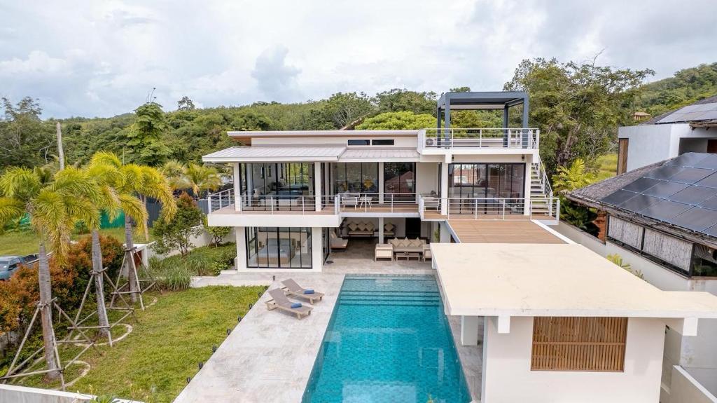 an aerial view of a house with a swimming pool at ANDAMAN Villa KOH YAO NOI in Ko Yao Noi