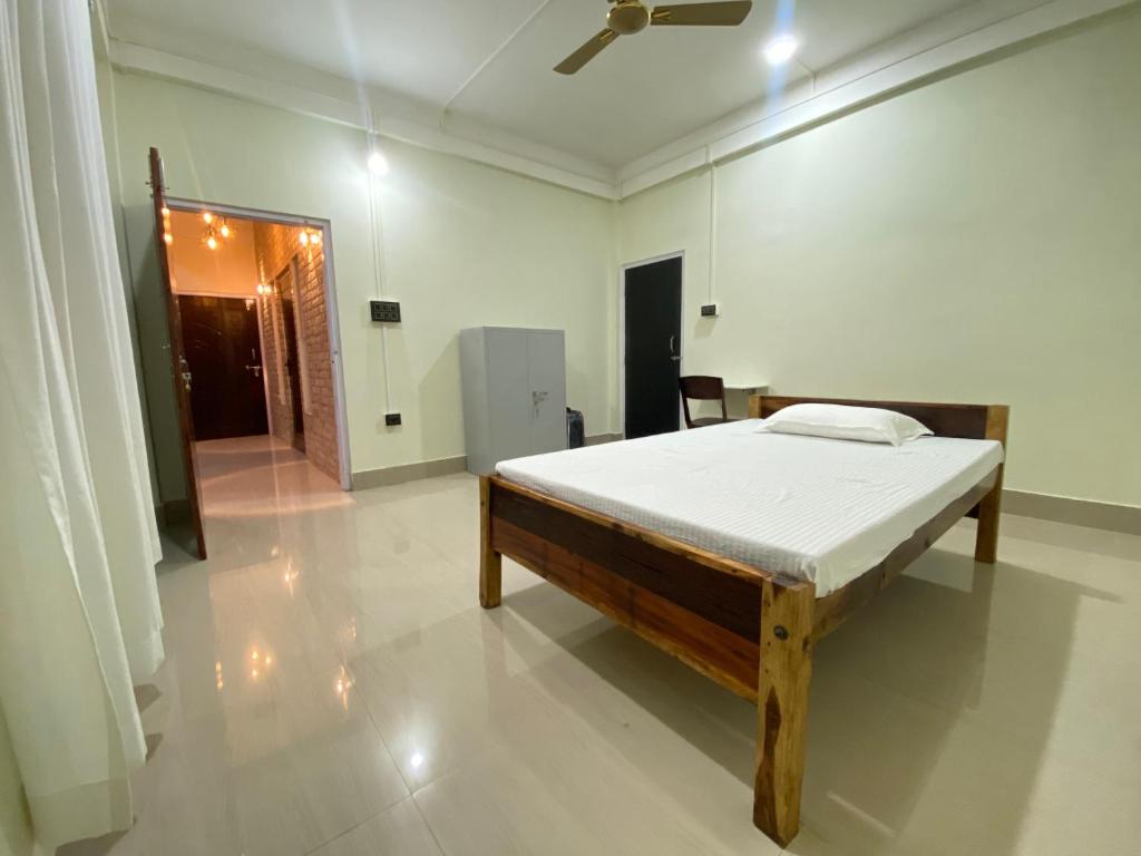 a bedroom with a bed in the middle of a room at Miro Homestay in Tura