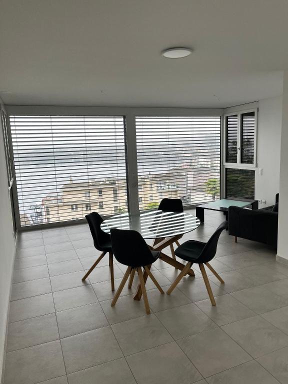 a living room with a table and chairs and a couch at Via privata in Lugano