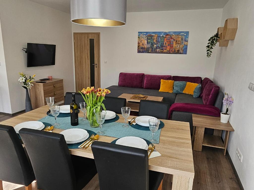 a living room with a table and a couch at Apartmán u Týnky in Frymburk