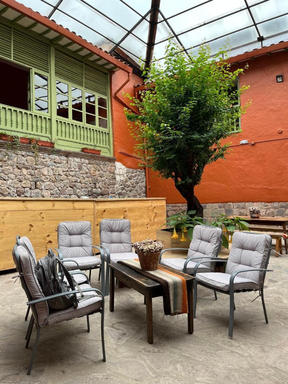a group of chairs and a table in front of a building at Casa Terra Cusco in Cusco