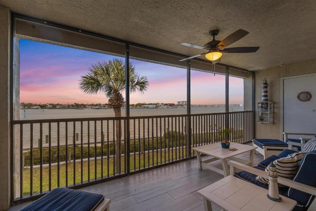 a screened porch with a view of the ocean at Bouchelle Island 203 in New Smyrna Beach