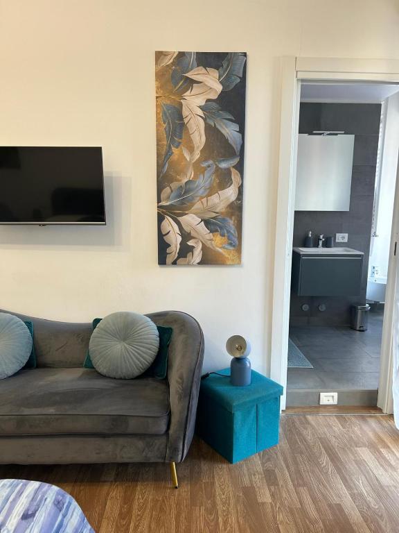 a living room with a couch and a painting on the wall at Comfort Accommodation Room in Bergamo