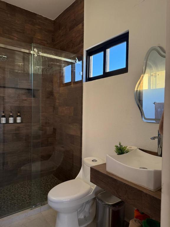a bathroom with a toilet and a sink and a shower at chema in Cabo San Lucas