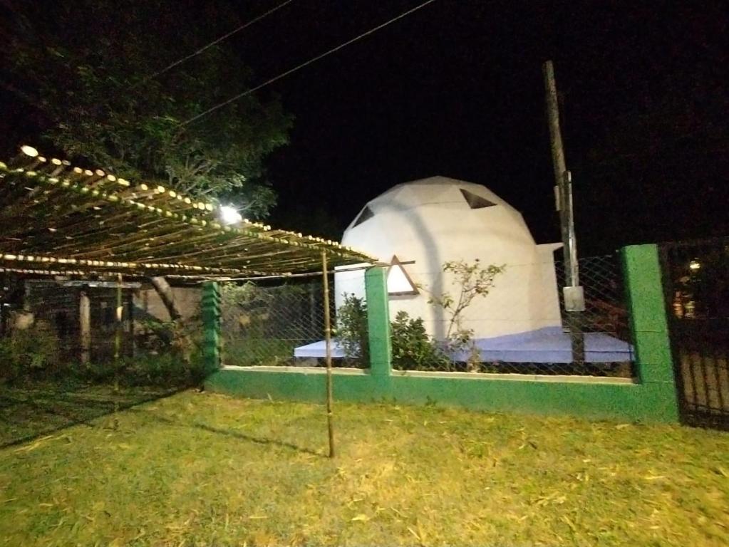a white dome tent in a yard at night at Domo Premium in Esquina