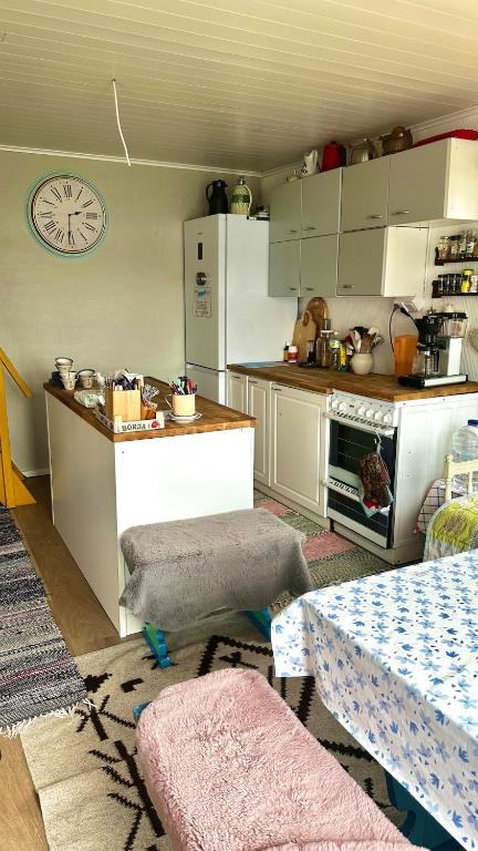 a kitchen with a table and a counter top at Summer cottage Taipalsaari in Vehkataipale