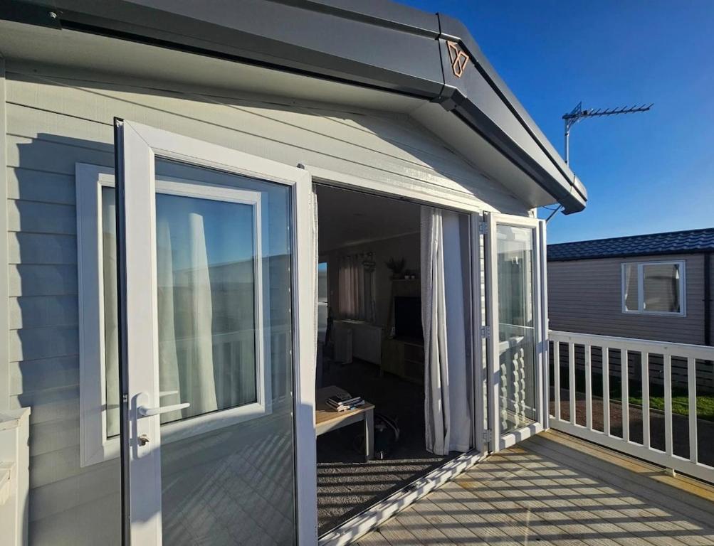 an open sliding glass door on a deck at Crozzer's Place in Heysham