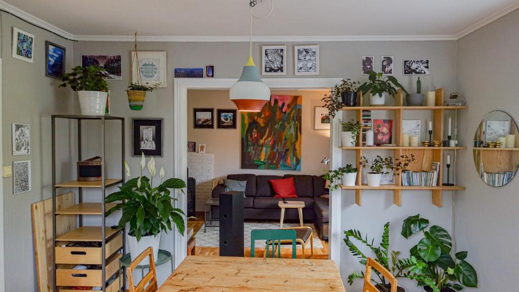 a living room with a couch and a table with plants at Svingen Apartments in Balestrand