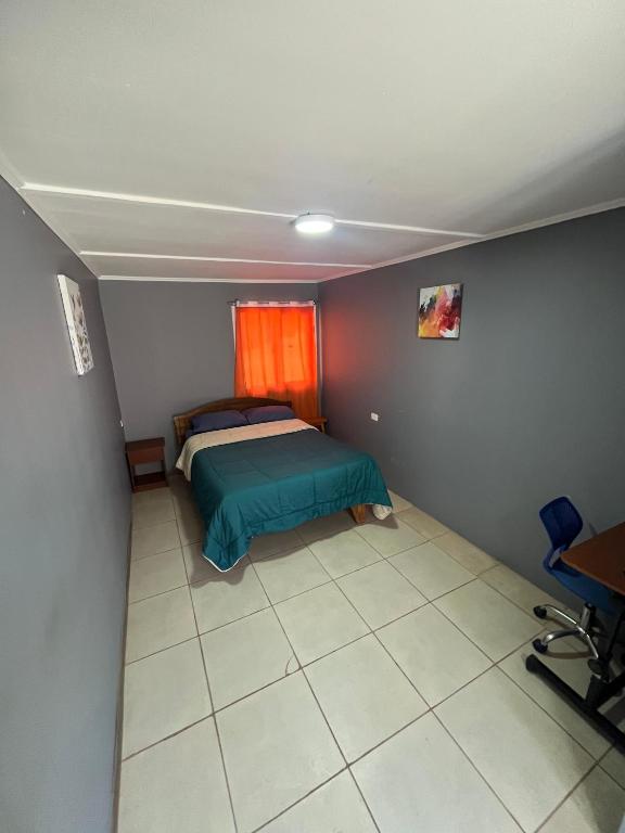 a small bedroom with a bed and a window at Hostal JV Loft Simple in Nogales