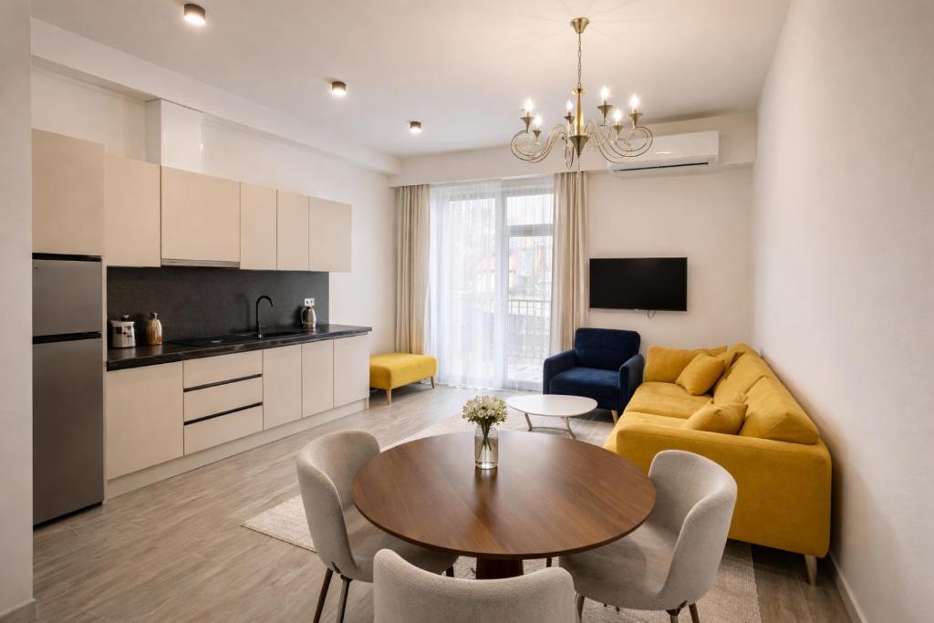 a living room with a yellow couch and a table at Verinn Apart Hotel in Dilijan