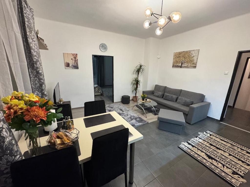 a living room with a table and a couch at Apartment PMH in Veľká Mača