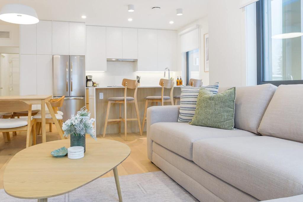 a living room and kitchen with a couch and a table at Summit Central in Revelstoke