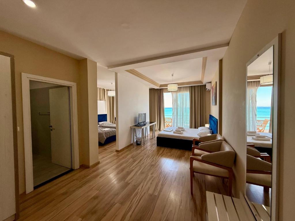 a hotel room with a bedroom and a living room at Hotel Amaiià in Sarandë