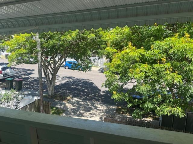 a view of a park with trees and a parking lot at Gabba Beautiful rooms in Brisbane